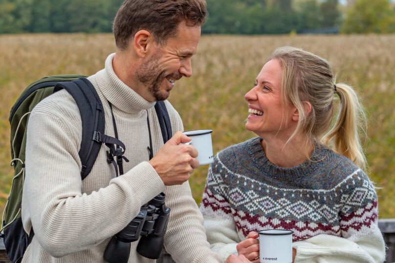 mies ja nainen hymyilevat ulkona