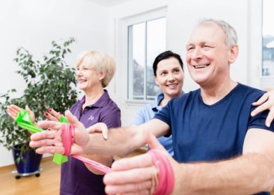 Older patients in physiotherapy using power band for strength training