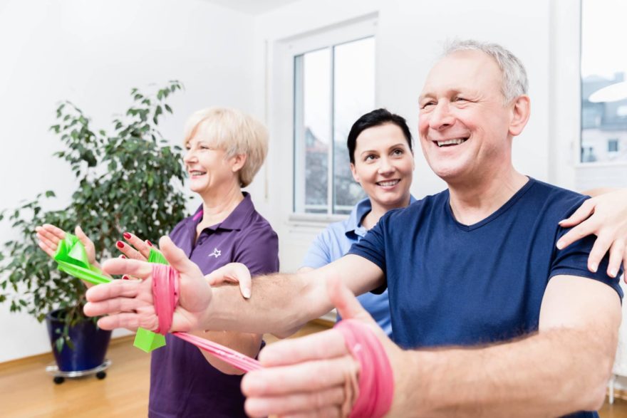 Older patients in physiotherapy using power band for strength training