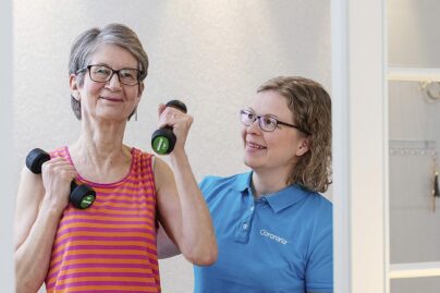 Vanhempi nainen jumppaa fysioterapeutin kanssa