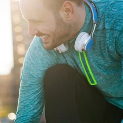 Man and woman wearing jogging clothes tying shoelaces.